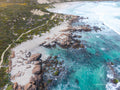 Aerial view of Redgate Beach, Margaret River, featuring turquoise ocean, rocky reef, white sand and the rugged South West WA coastline.
