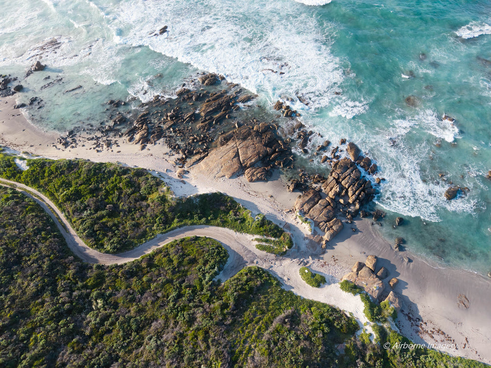 Aerial view of Elephant Rock Beach, Deepdene, featuring turquoise ocean, granite rocks, white sand and a winding coastal track in South West WA.